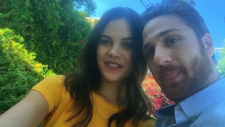 A clip of a male and a female taking a selfie together