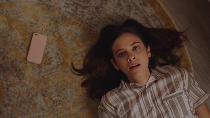 A woman wakes up from a nightmare scared