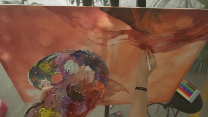 Point of view of an artist painting on canvas