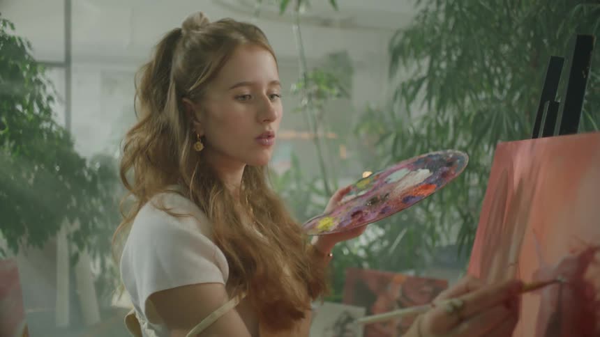 Artist painting on canvas with oils