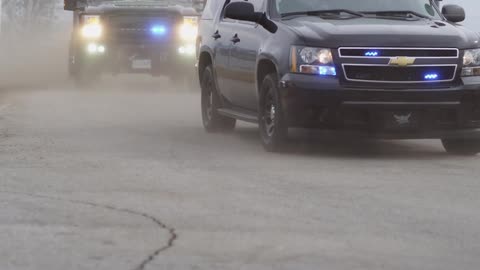 Police vehicles passing on a street