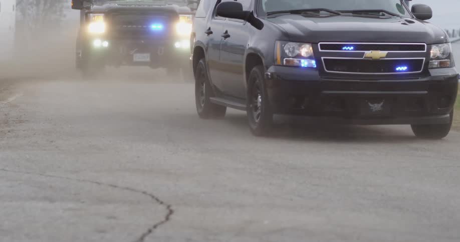 Police vehicles passing on a street