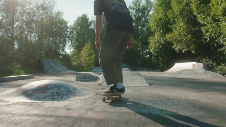 There is a young man that is skate boarding at a park