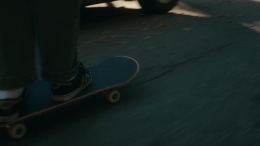 There is someone skateboarding in the middle of the street