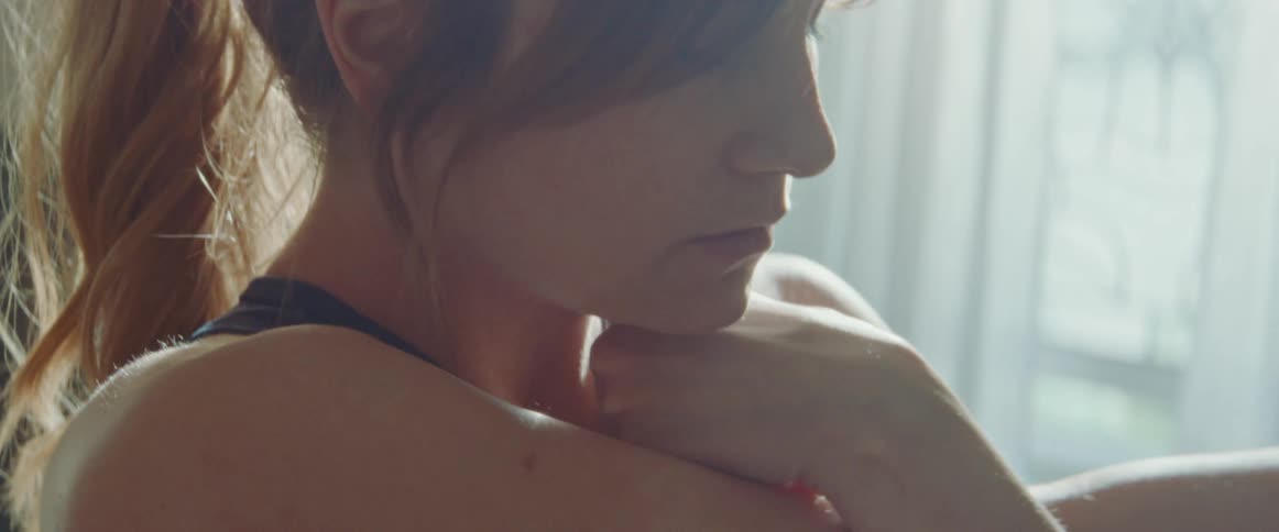 A woman is stretching inside of her house