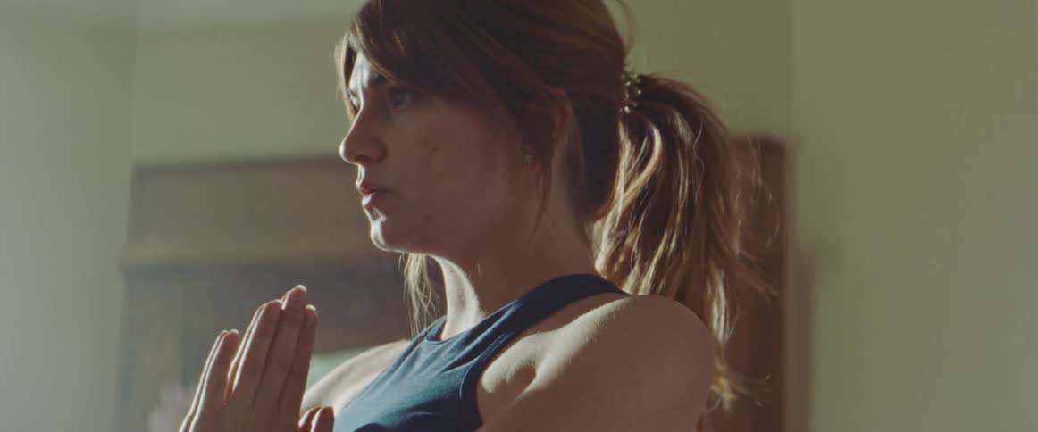 A woman is doing yoga inside a room