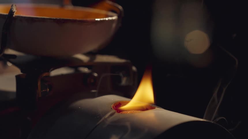 Boiling liquid is being poured into a burning hole