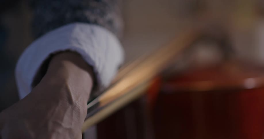 A person tuning a cello