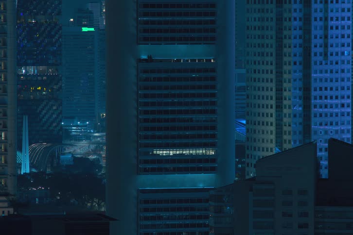 Interior lights from downtown buildings turn off during the night