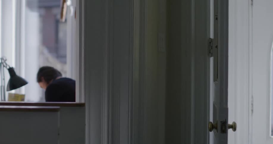 Person opening a door in a room with other people