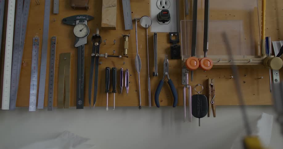 Various tools are hanging on the wall of the garage