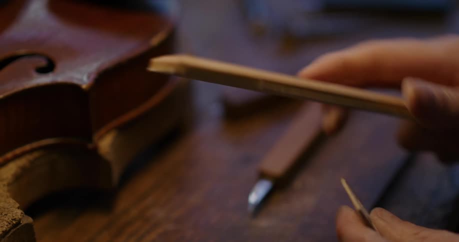Closeup of a persons hands sanding an object