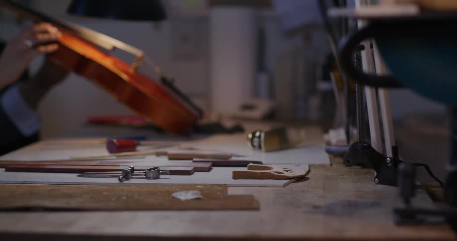A worker is repairing a voilin