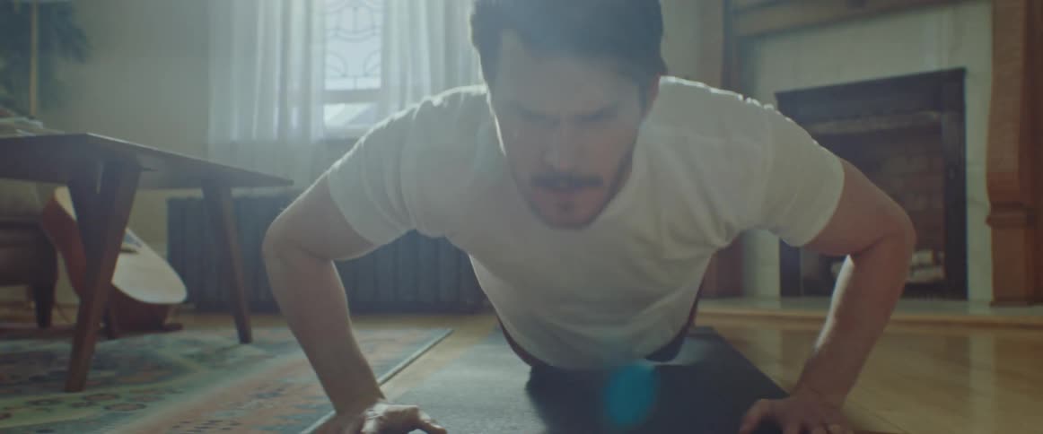 A man is doing push ups in his living room