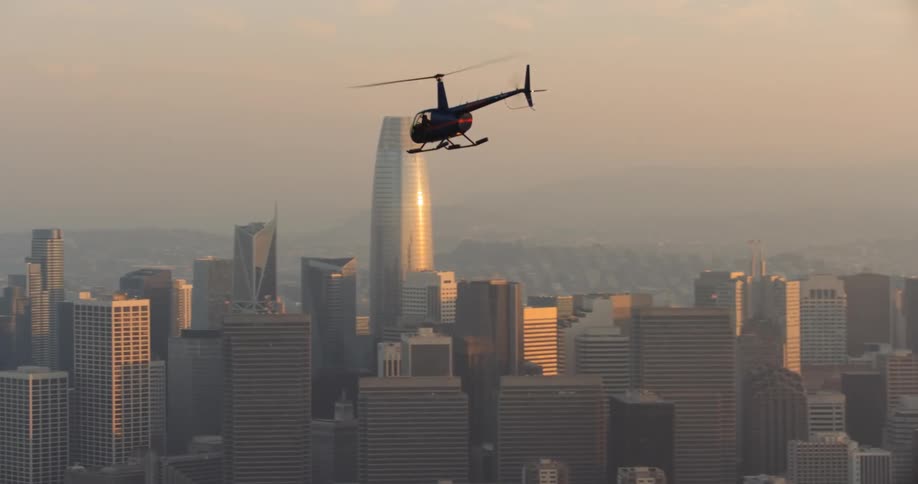 San Francisco, A helicopter flying over the foggy city in the late afternoon