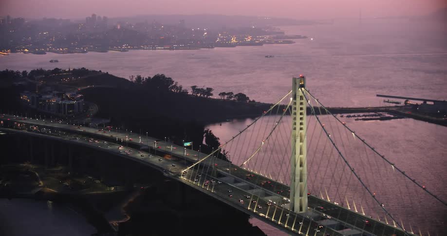 Aerial view of cars crossing the san francisco bay bridge at dusk