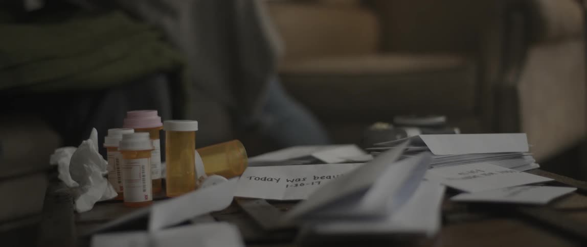 Pill bottles and papers cover a table