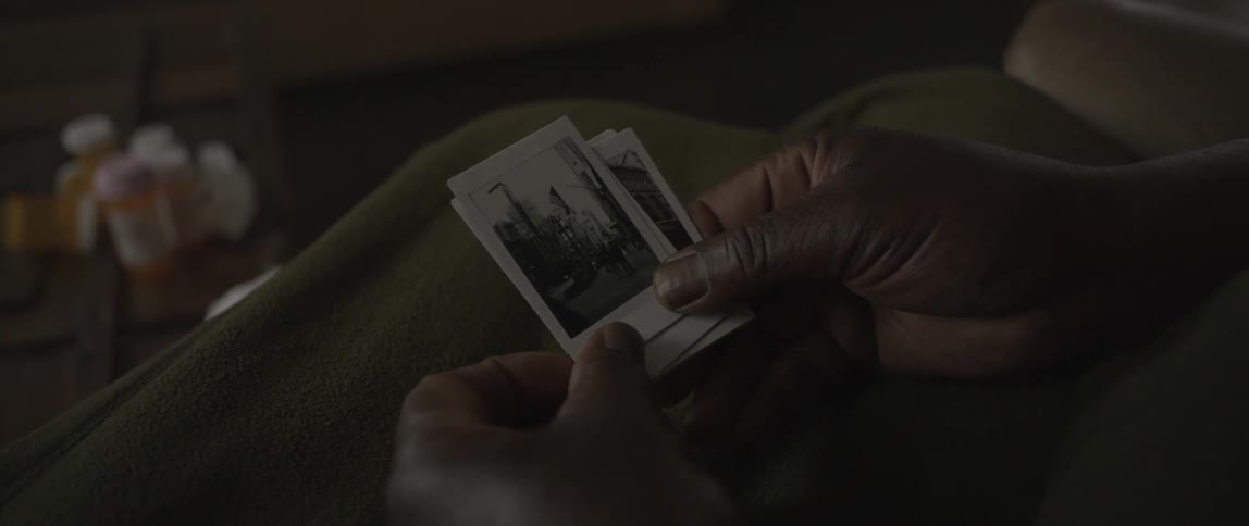 A man looks through a batch of black and white photos
