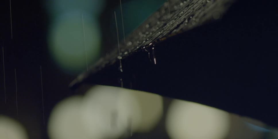 Close up of rain dripping from an umbrella