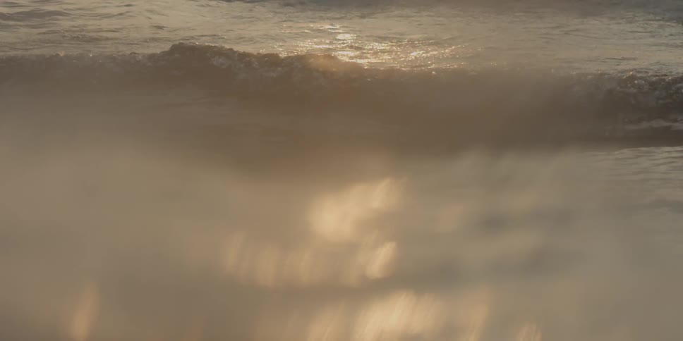 Light shines on foamy waves