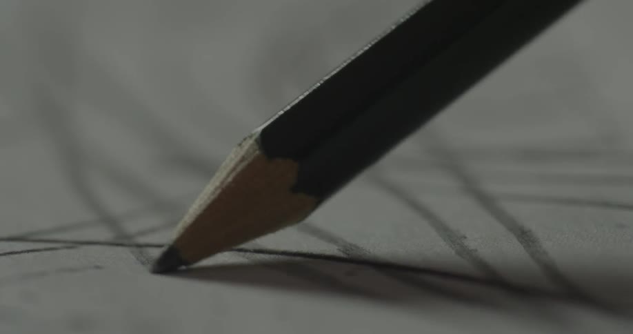 A pencil draws a line across a paper