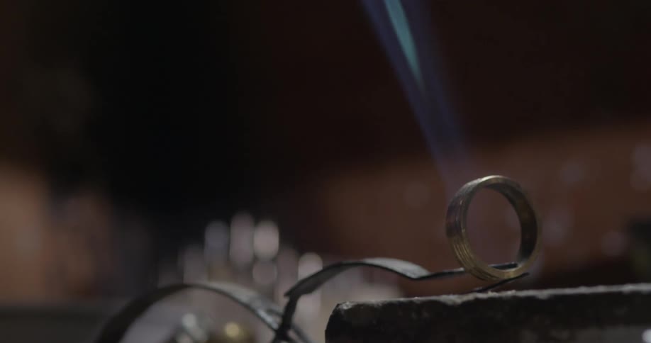 Someone uses a blowtorch on a ring