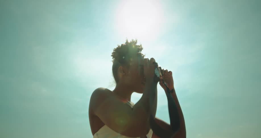 A young woman taking photos with a camera