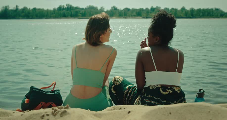 Two women are talking by the water