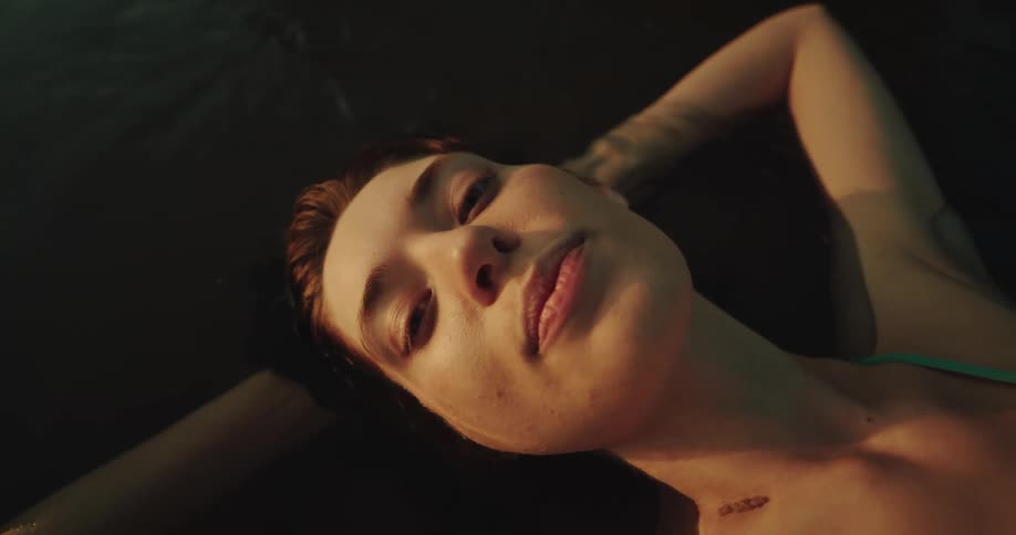Closeup of a womans face relaxing in the water