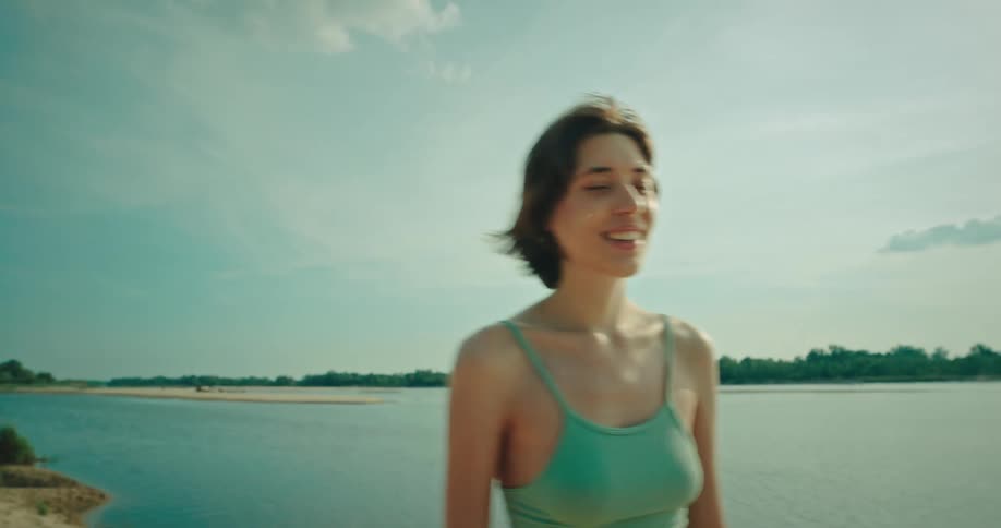 A young woman playing frisbee at the beach