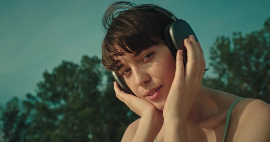 A woman is listening to music on her headphones