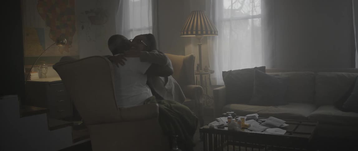 A man and young woman share a hug and smiles