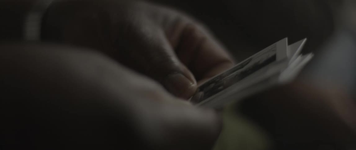 A person looks at several photographs