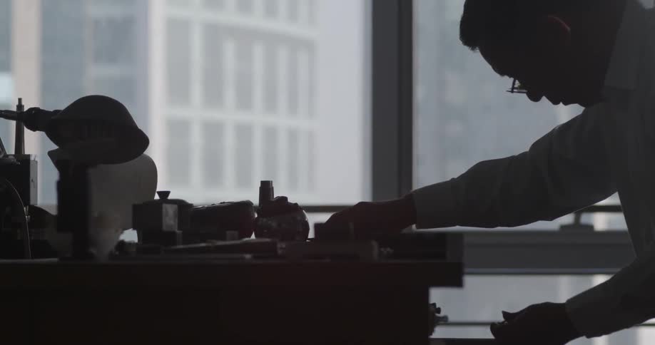 Man grabs tools from table to work on his project