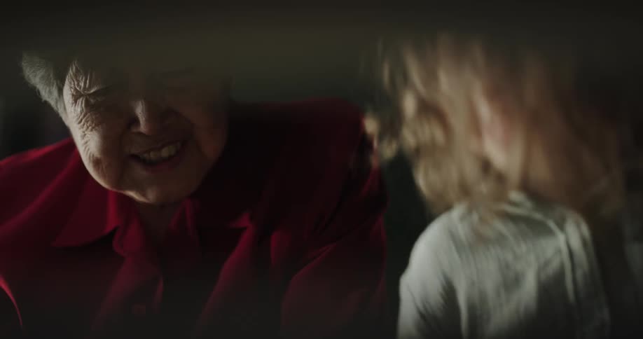 Grandmother happily talking to her granddaughter