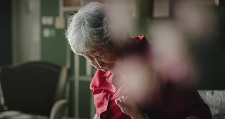Grandmother with her granddaughter who is lying in bed