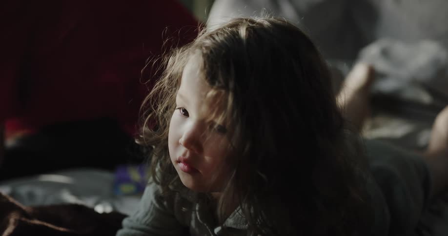 Portrait of a little girl lying on the floor