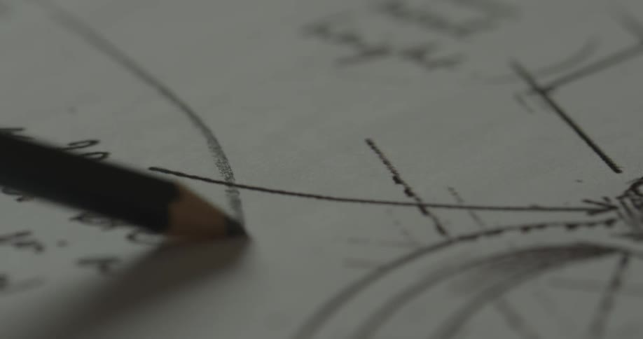 A person drawing a line with a pencil on a paper with writing and lines