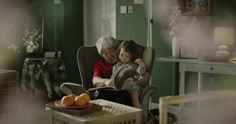 A clip of a grandmother reading to her granddaughter