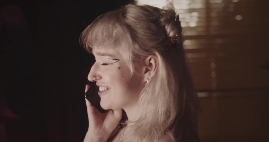 Teen hugs her mom with happiness after talking on phone in a room