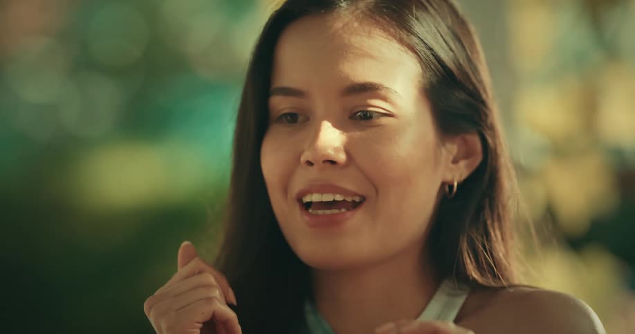 A woman is smiling and talking