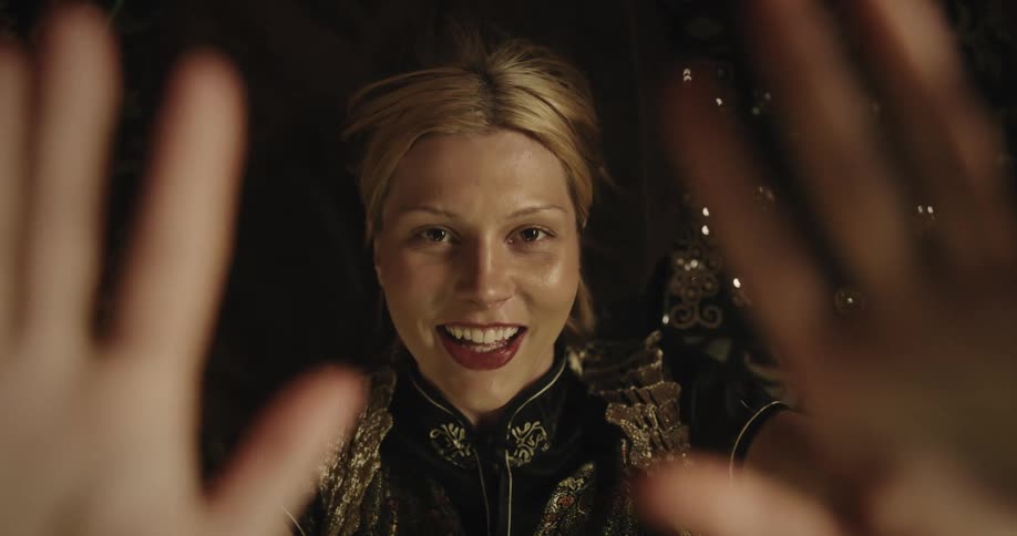 Portrait of a young blonde woman lying down blowing a kiss and smiling