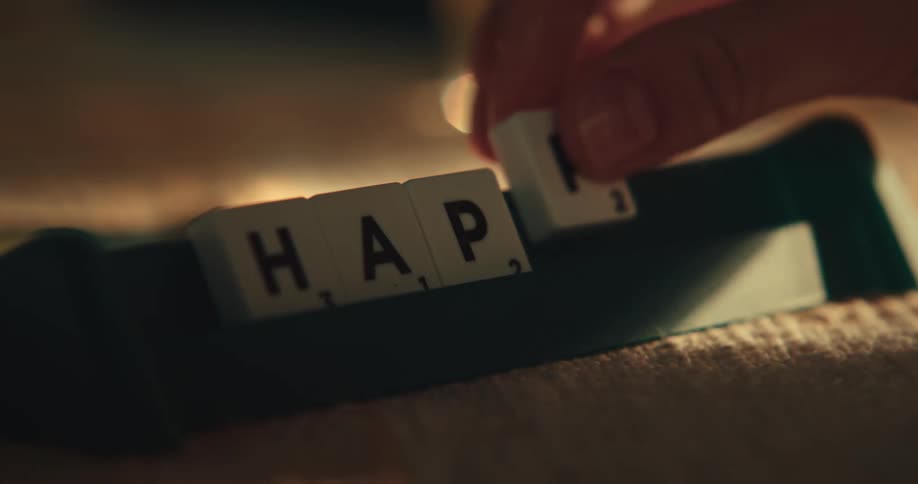 A person is playing the game scrabble
