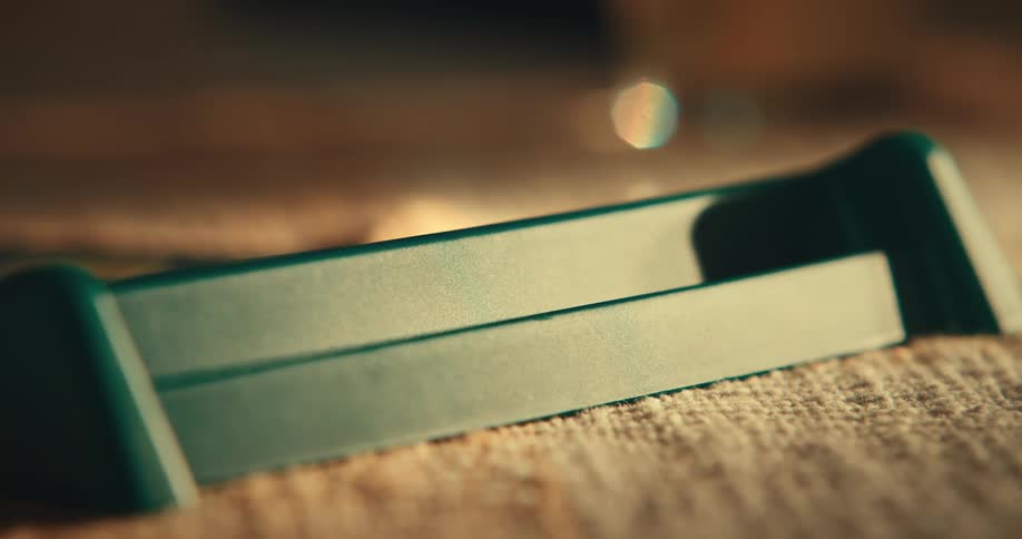 Closeup of fingers assembling a word on an object