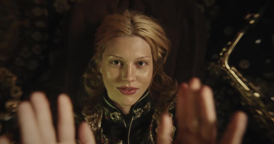Portrait of a young blonde woman blowing a kiss