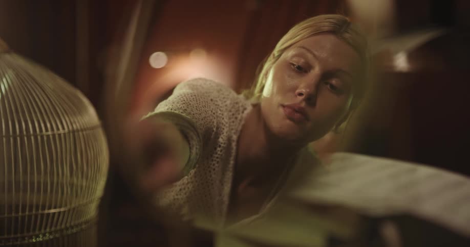 View of a mirror reflecting a young blonde woman