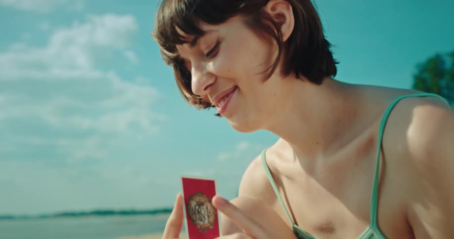 A clip of two friends playing a card game by the beach side
