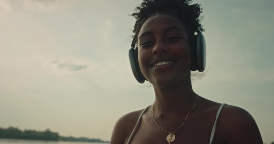 Portrait of a woman listening to music with wireless headphones