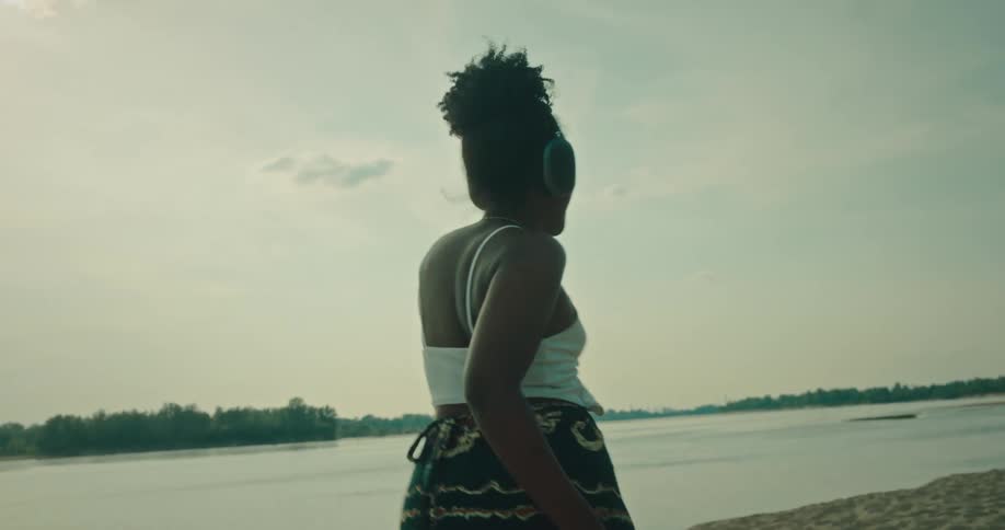 A woman is dancing in the sand