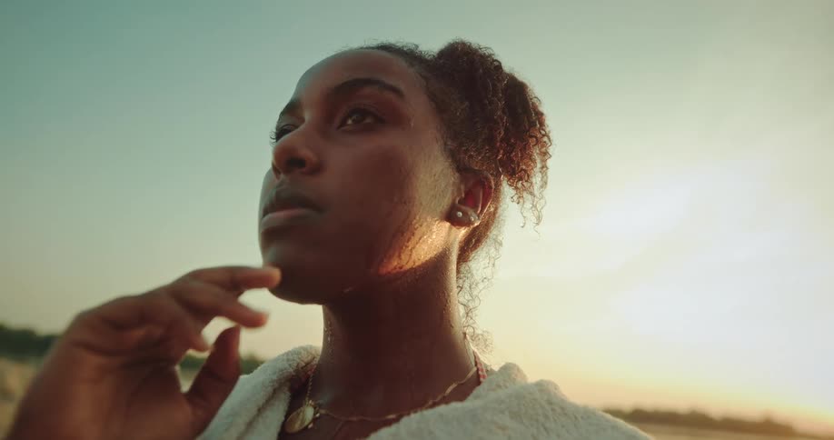 A woman wipes water on her face